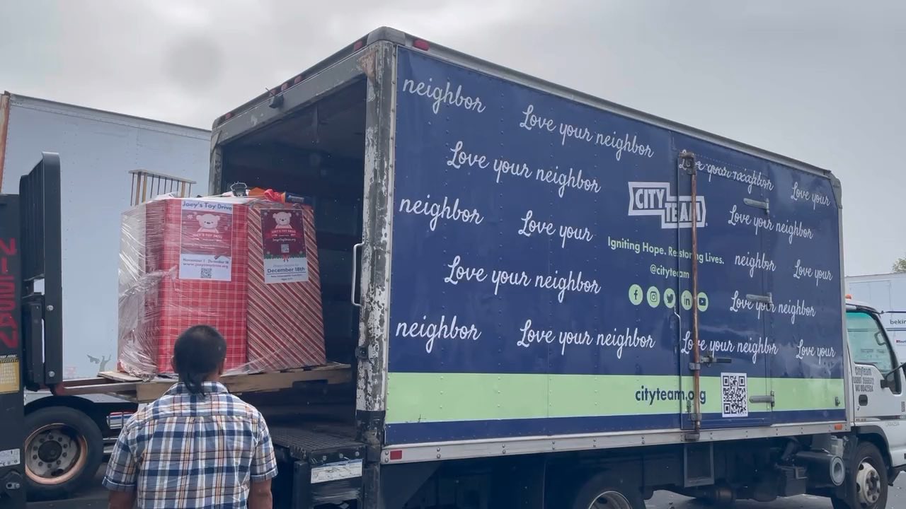 A pallet of Joey's Toy Drive collection boxes loaded onto a CityTeam box truck