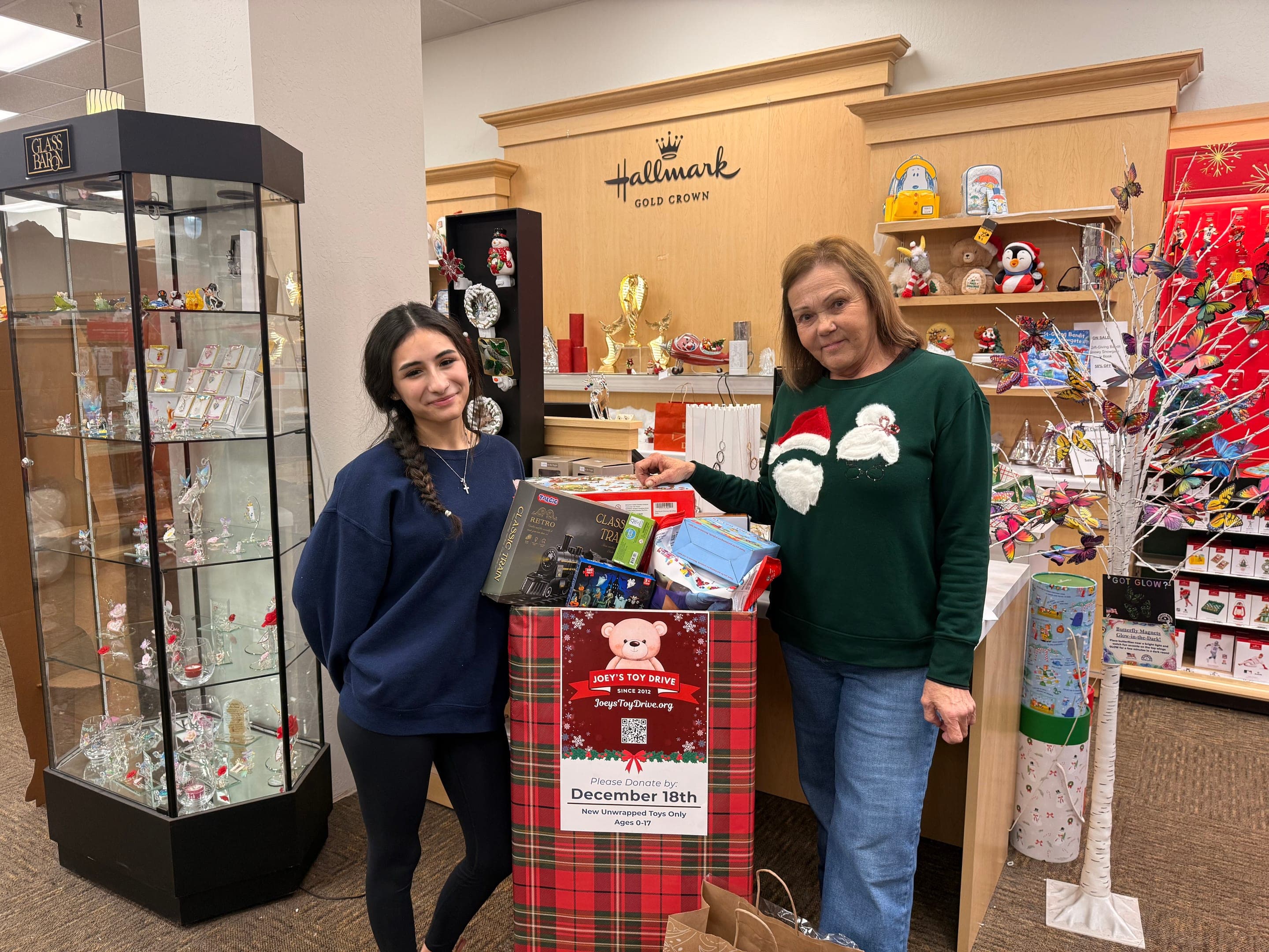 A local store team beside their Joey's Toy Drive donation box